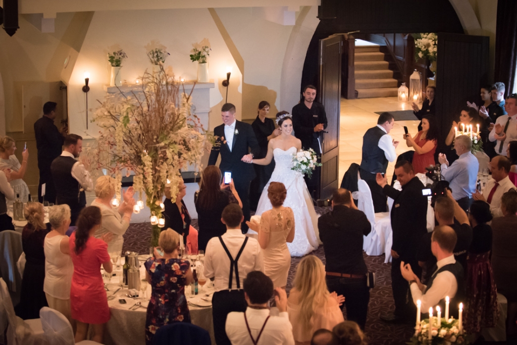 Bride and Groom walking into the wedding reception room