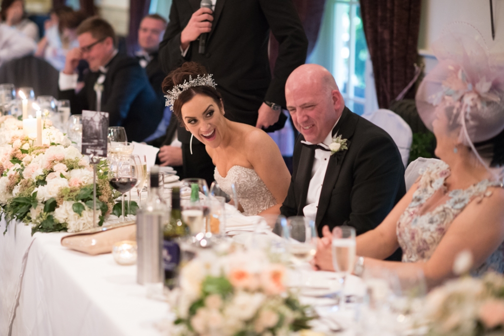 Bride laughing at the grooms wedding speech 