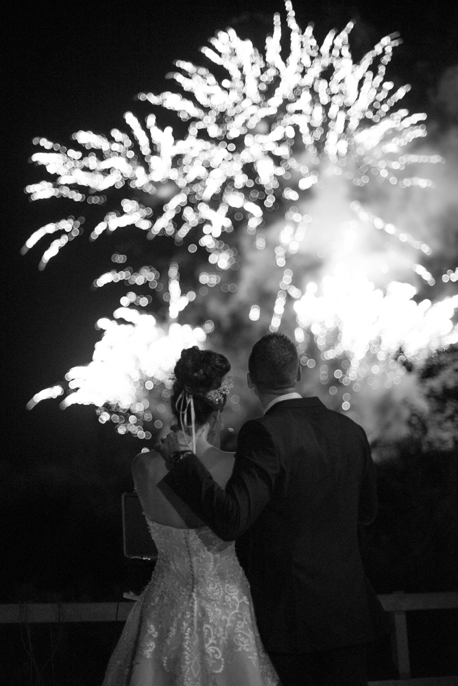 Bride and groom watching the wedding fireworks