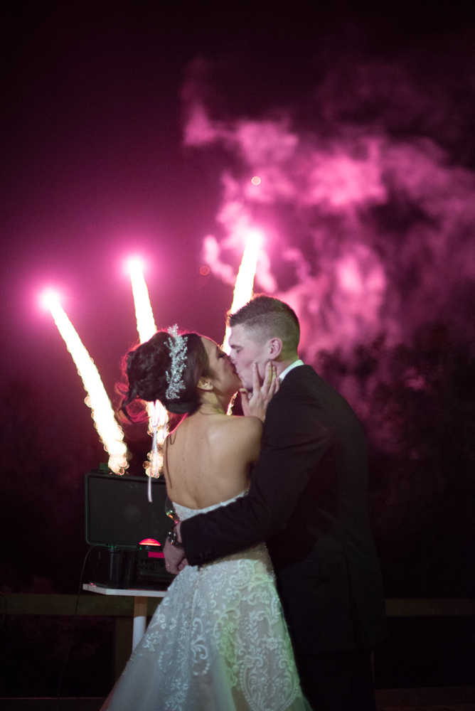 Bride and Groom kissing during the fireworks 