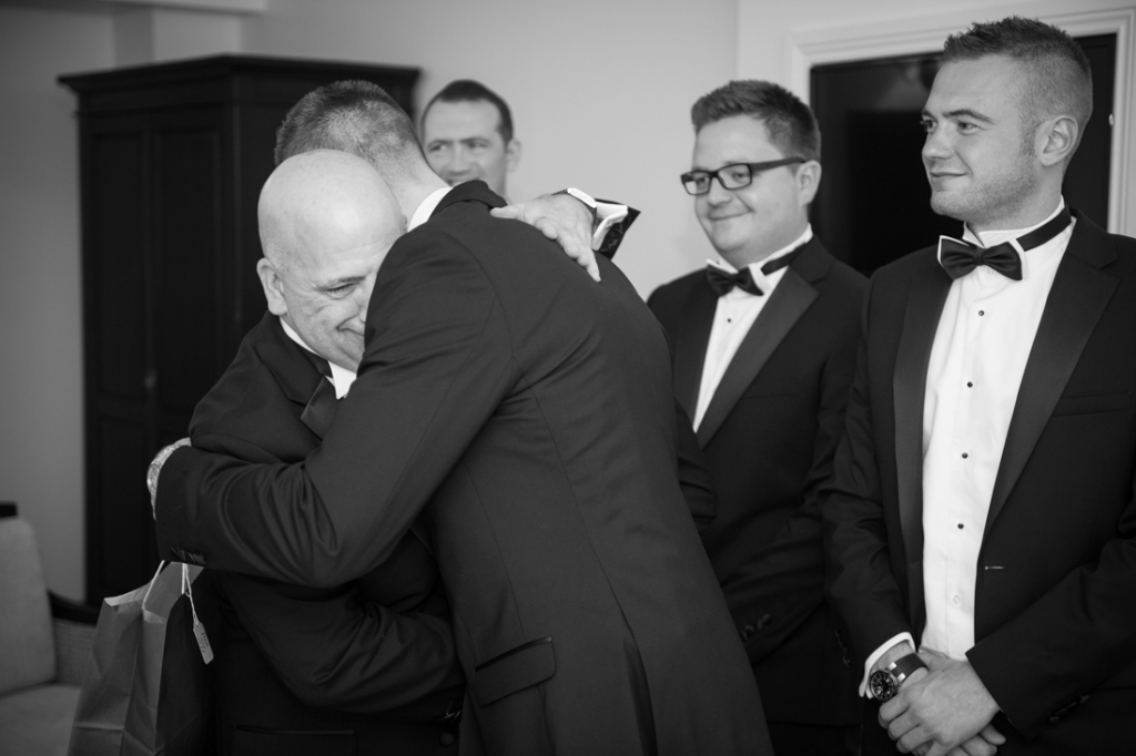 Groom and his father hugging 
