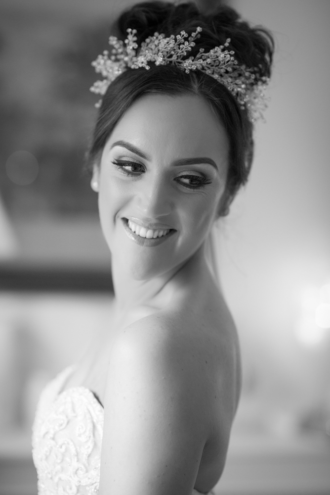 Bride laughing wearing her wedding dress and hair piece