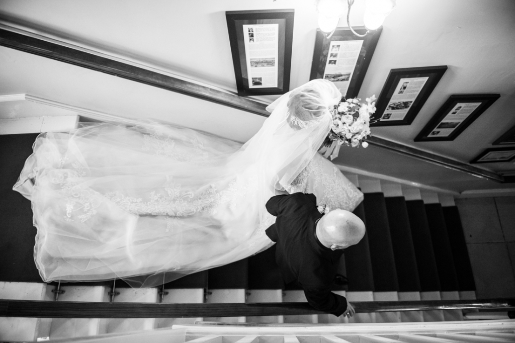 Birde and her dad walking down the stairs to go get married at Brooklodge