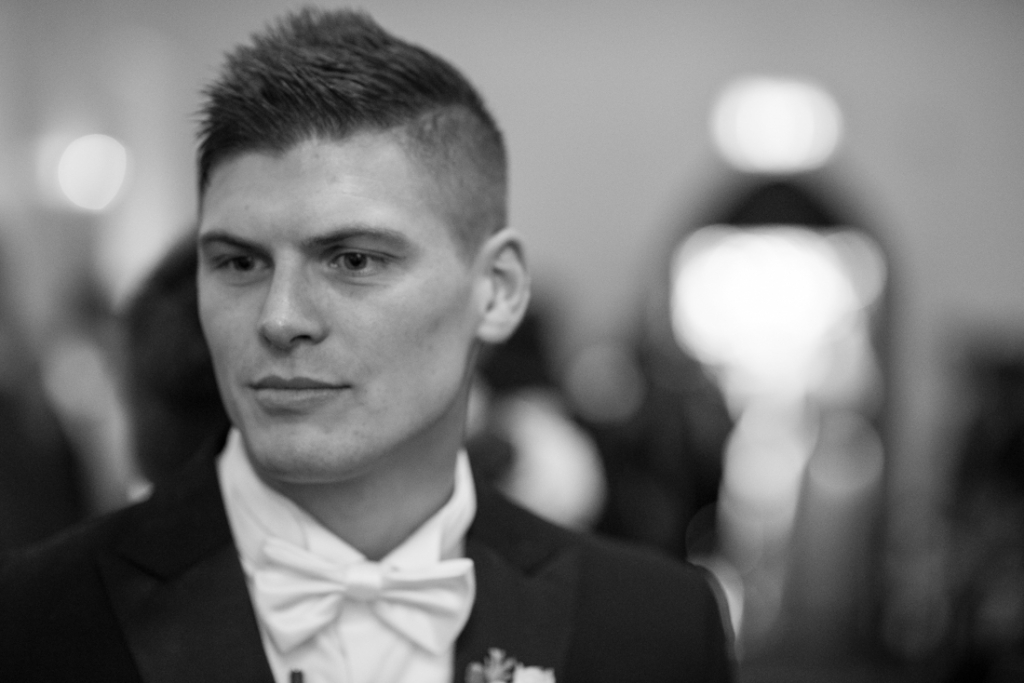 Groom at the top of the aisle waiting for his bride