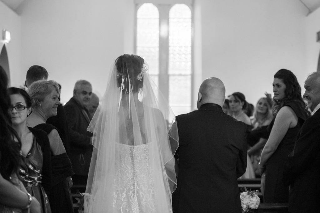 Bride and her dad walking up the aisle at the chapel at Brooklodge