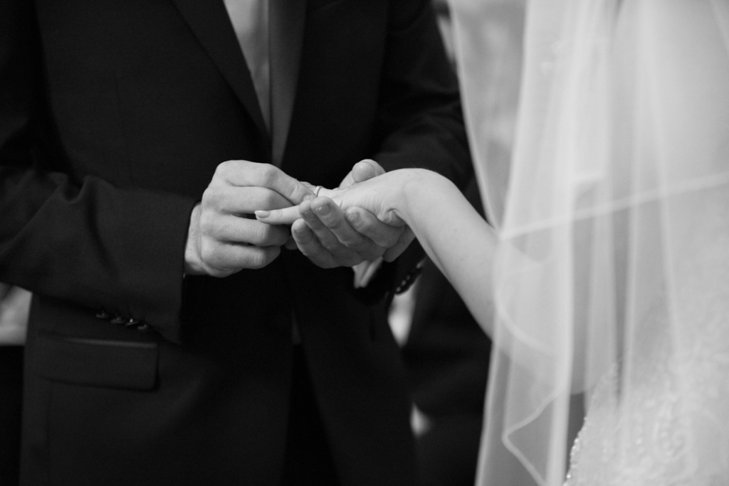 Bride and groom exchanging wedding rings