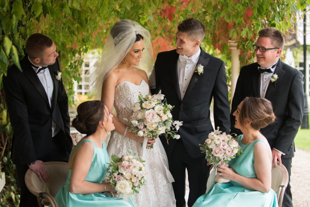 Bride and groom and bridal party laughing together