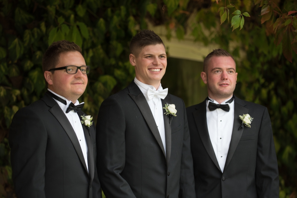 Groom and his groomsmen in their black tie suits