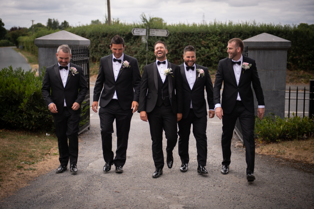 groomsmen walking by wedding photographers the fennells radisson blu wedding