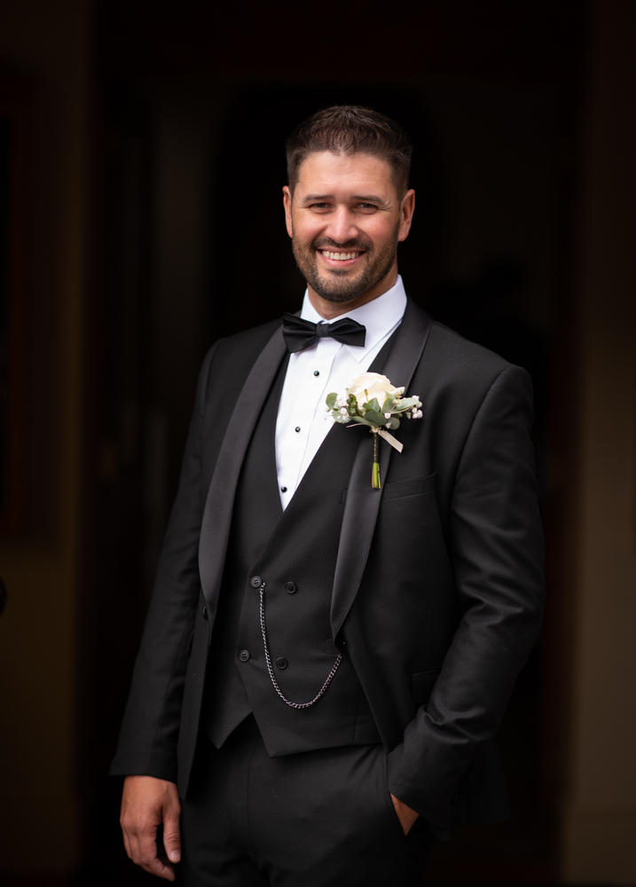 radisson blu wedding groom at church door by wedding photographers the fennells