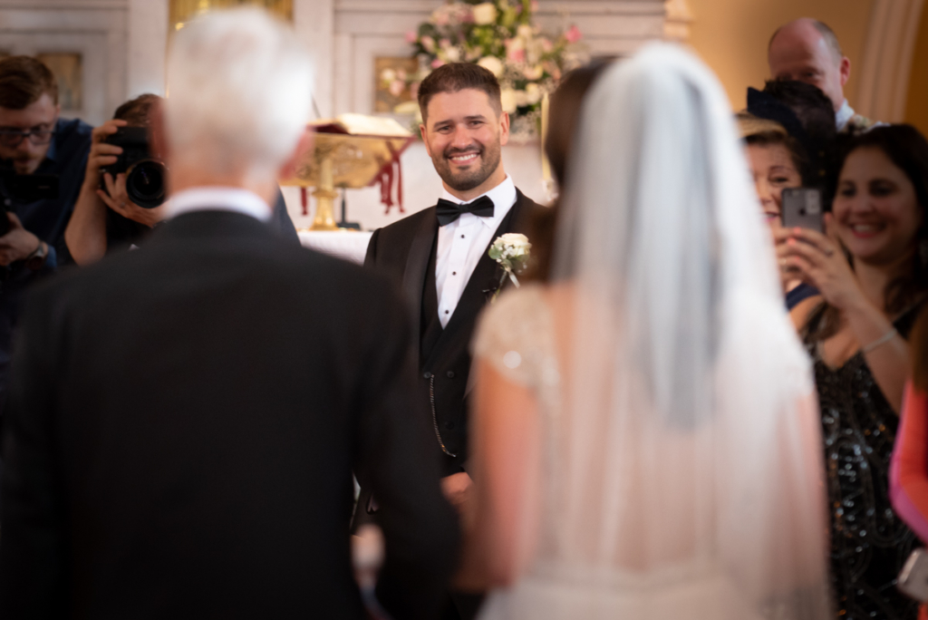 radisson blu wedding groom seeing bride by wedding photographers the fennells