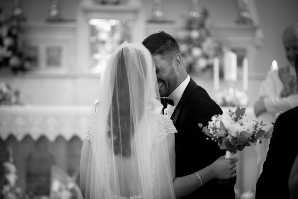 groom hugging bride