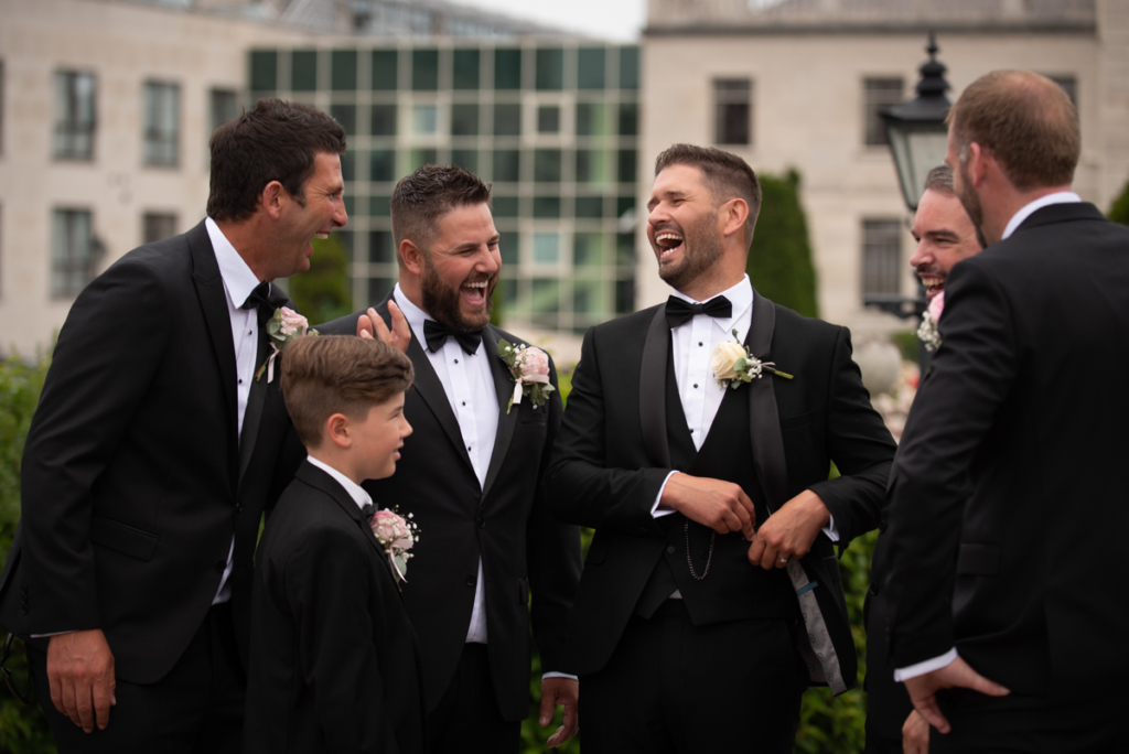 radisson blu wedding groomsmen laughing photo by wedding photographers the fennells