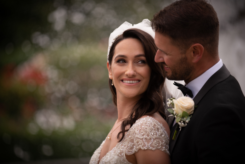 couple embrace photo by wedding photographers the fennells