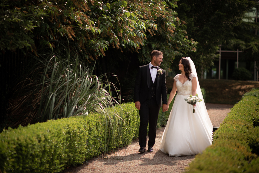 walking in garden photo by wedding photographers the fennells radisson blu wedding