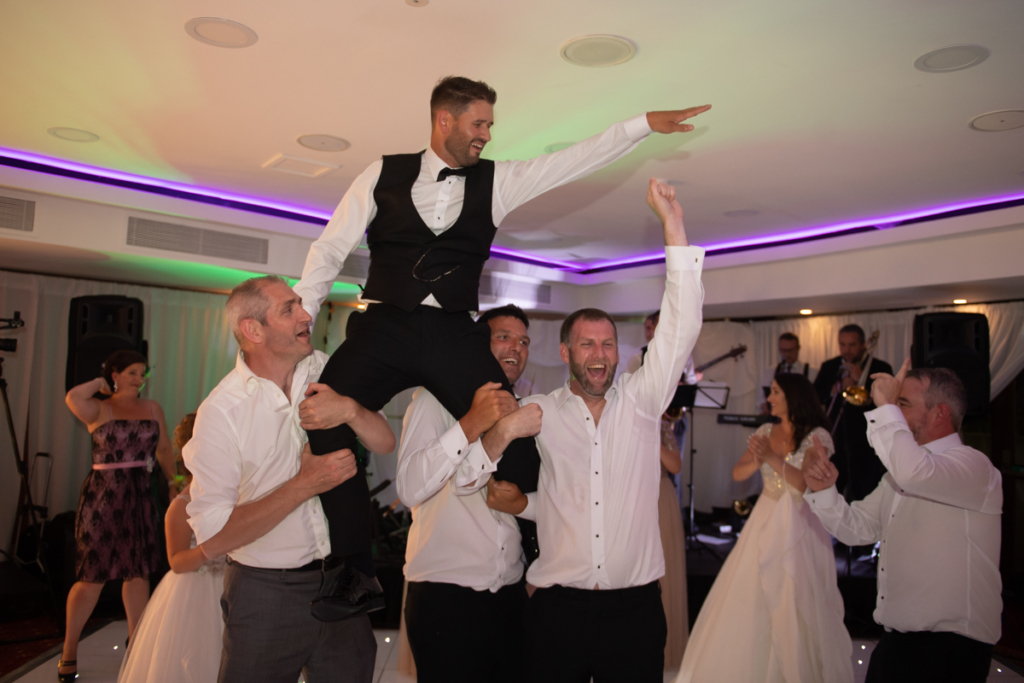 groom dancing on shoulders