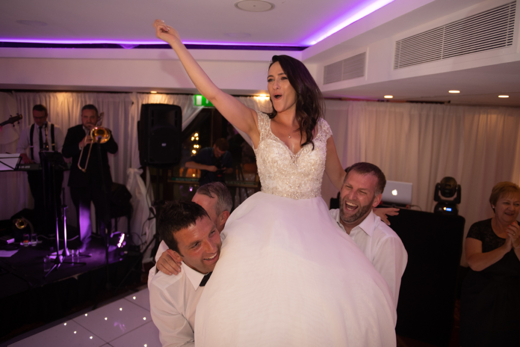 bride dancing on shoulders