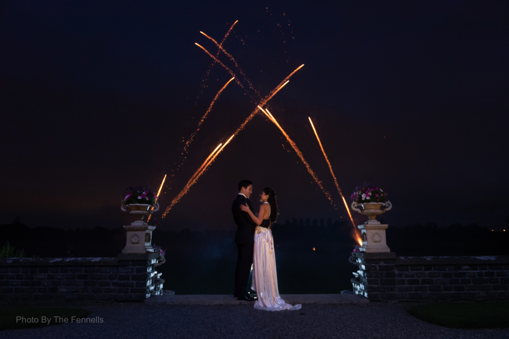 Sarah Roberts and James Stewart standing under the fireworks at Luttrellstown Castle