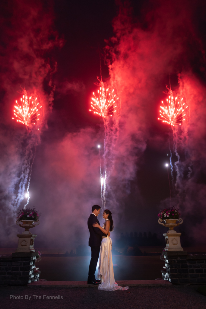 Sarah Roberts and James Stewart standing under a display of fireworks at Luttrellstown Castle