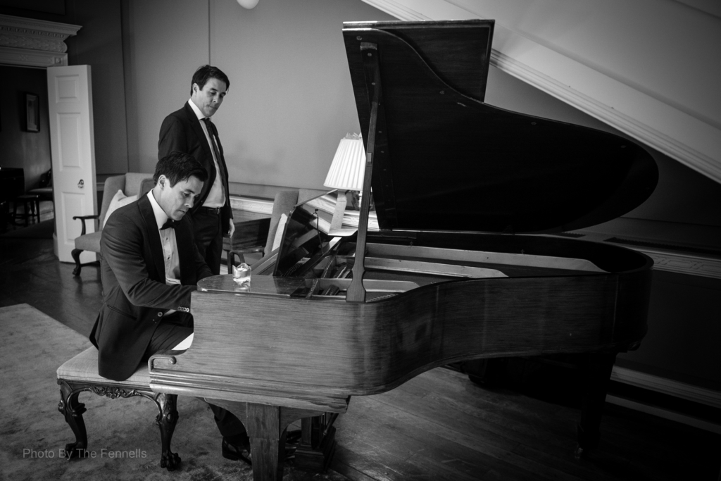 James Stewart playing the piano with his twin brother watching