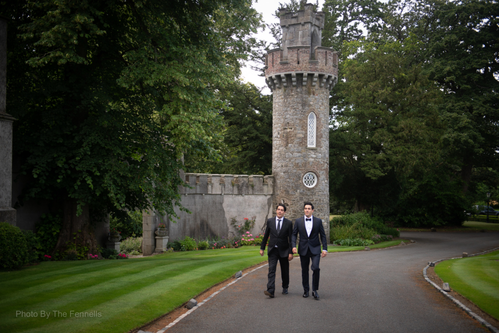 James Stewart and his groomsman walking on the grounds of Luttrellstown Castle