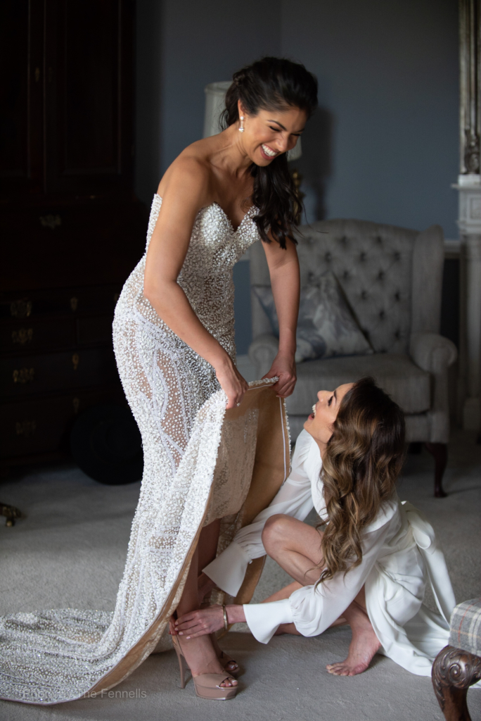 Sarah Roberts sister helping her into her wedding dress