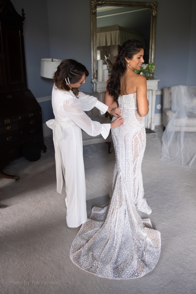 Sarah Roberts bridesmaid tying up her wedding dress