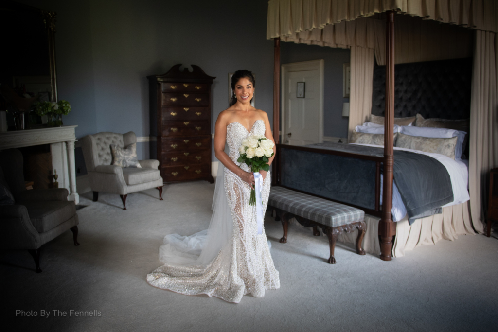 Sarah Roberts in her wedding dress and holding her flower bouquet in the bridal suite at Lutrellstown Castle