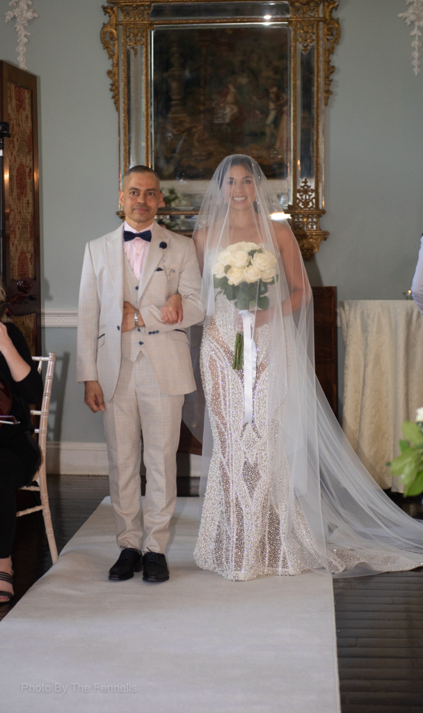 Sarah Roberts and her brother walking up the aisle at Luttrellstown Castle