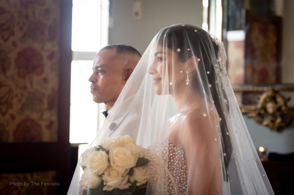 Sarah Roberts being walked up the aisle by her brother at Luttrellstown Castle