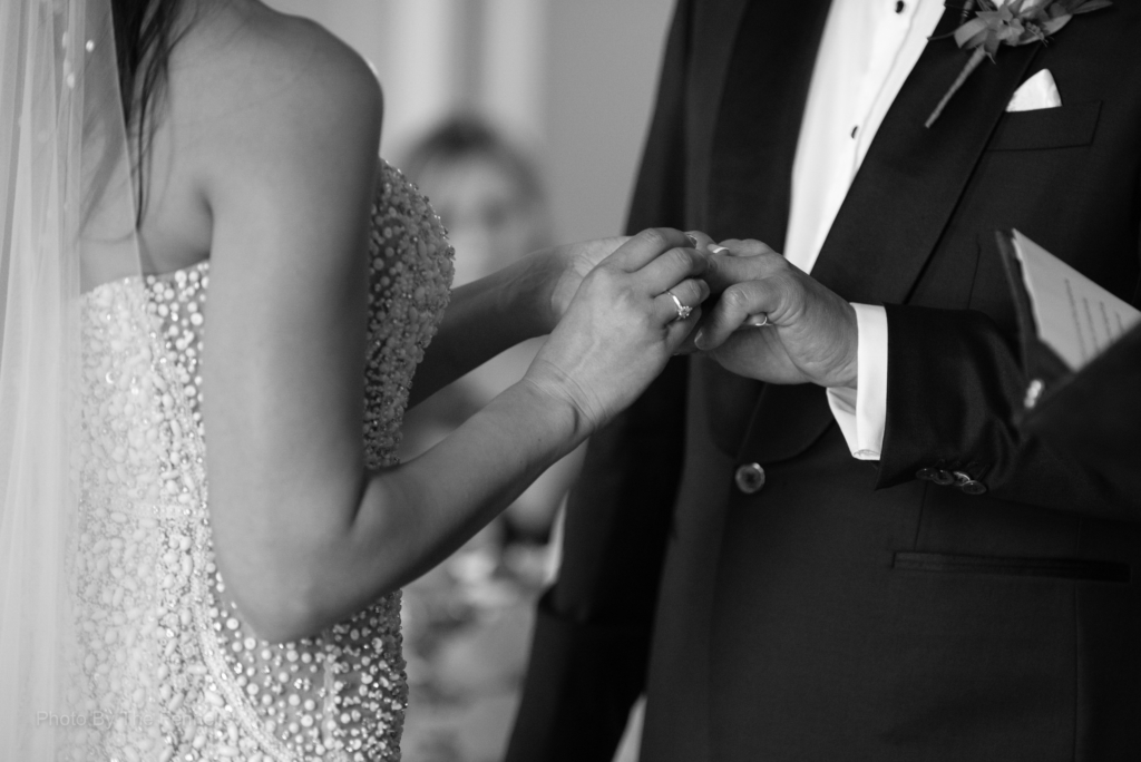 Sarah Roberts putting on James Stewarts wedding ring during their vows