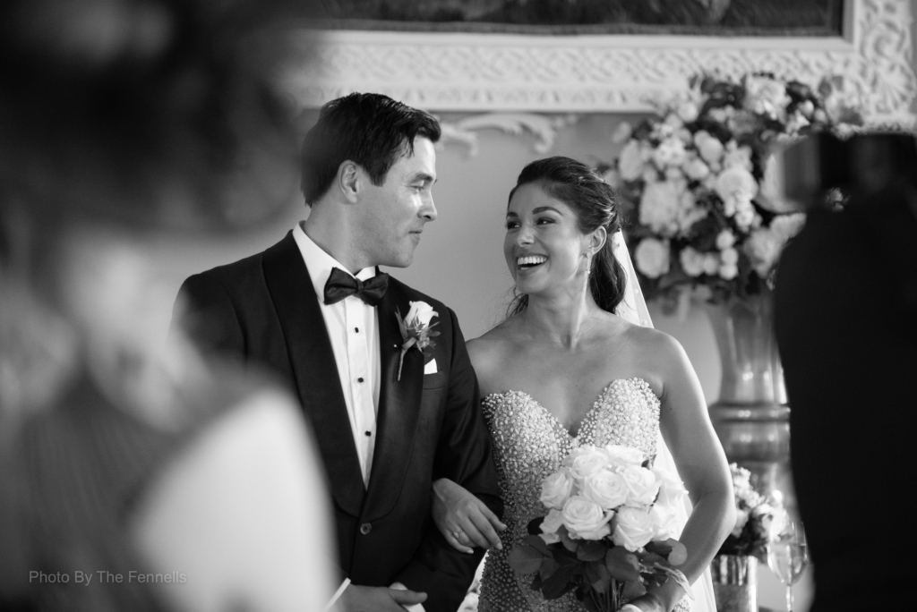 Sarah Roberts and James Stewart looking at each other and smiling at their wedding ceremony