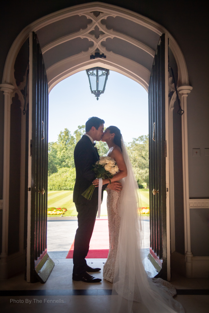Sarah Roberts and James Stewart kissing at the front door at Luttrellstown Castle
