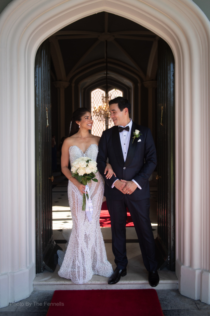 Sarah Roberts and James Stewart standing at the front door at Luttrellstown Castle for their wedding