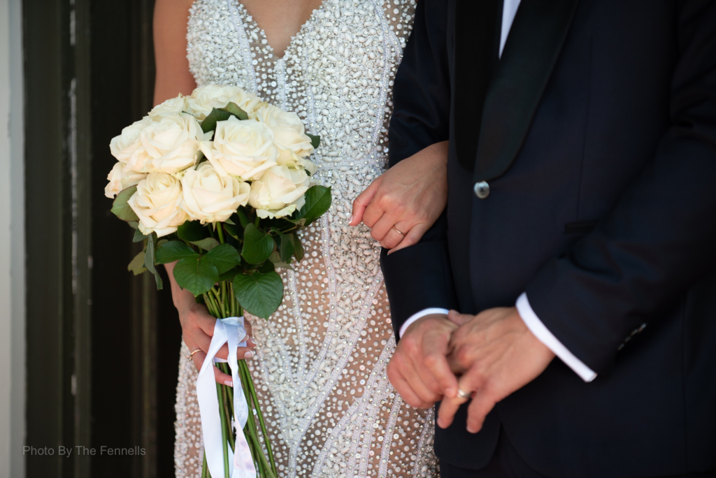 Sarah Roberts linking James Stewarts arm on their wedding day