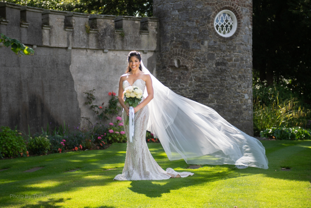 Sarah Roberts standing in the grounds of Luttrellstown Castle on her wedding day