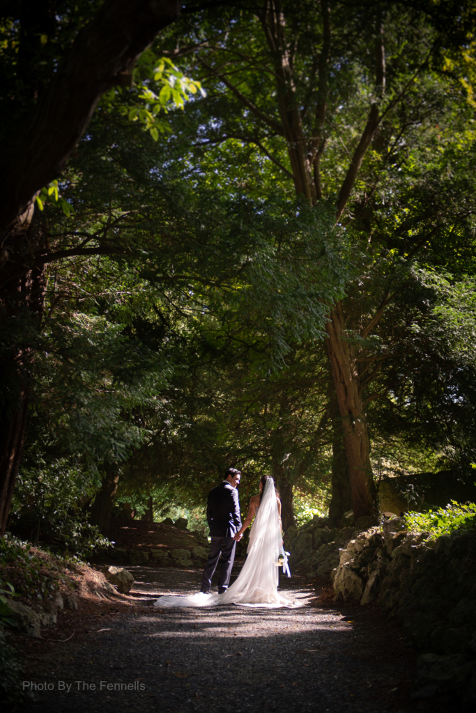 Sarah Roberts and James Stewart walking holding hands on the grounds of Luttrellstown Castle