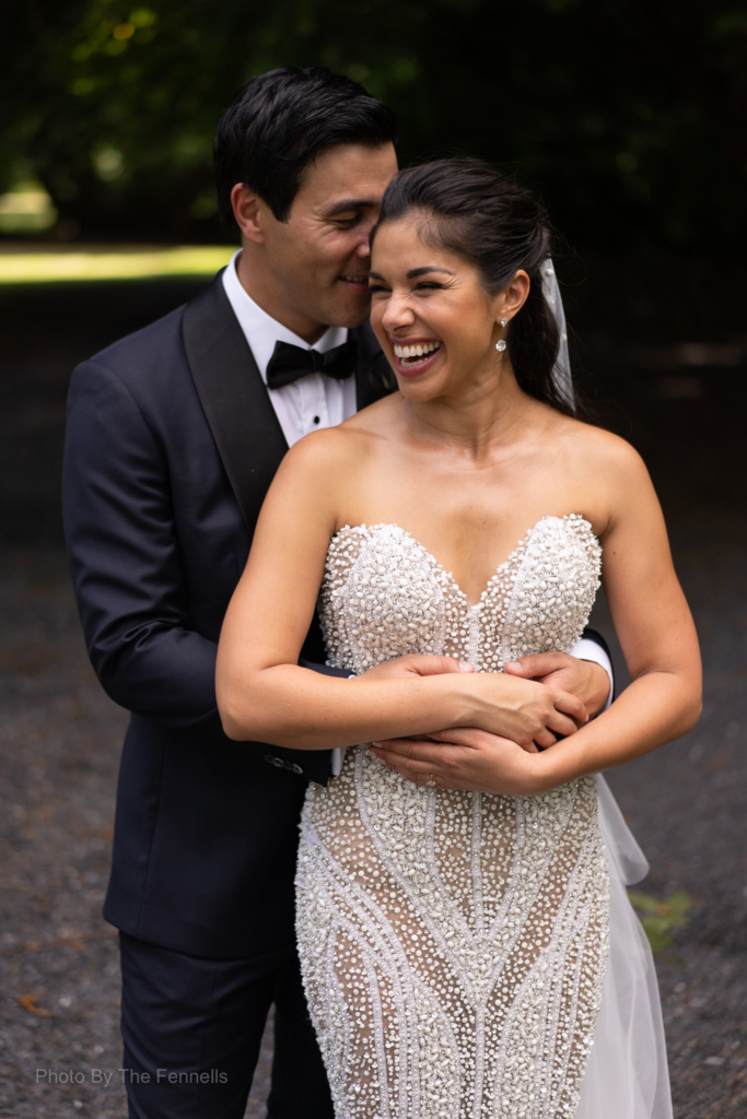 Sarah Roberts and James Stewart hugging and laughing together on their wedding day