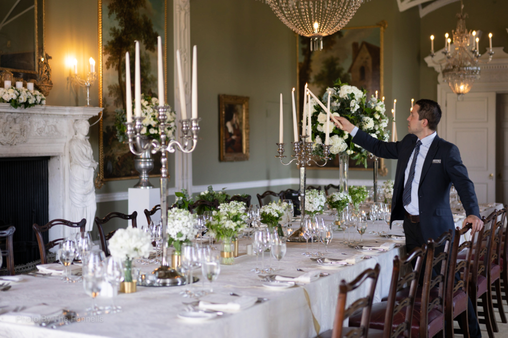 Lighting the candles on the candelabra for the dinner reception for the home and away wedding