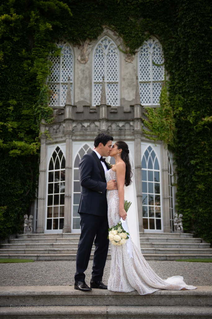 James Stewart and Sarah Roberts kissing on the steps at Luttrellstown Castle