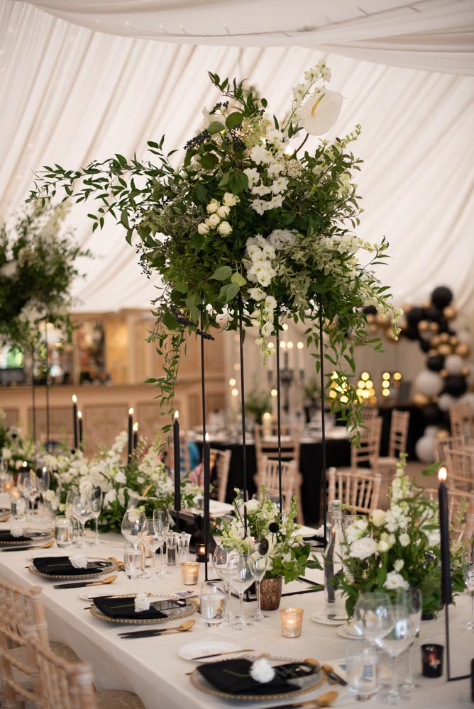 Geometic flower stands and table decor in the marquee at castle leslie