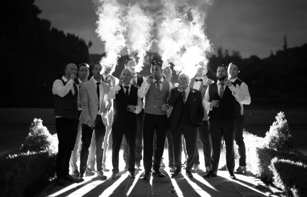 Groom and friends smoking cigars at his castle leslie wedding in Ireland