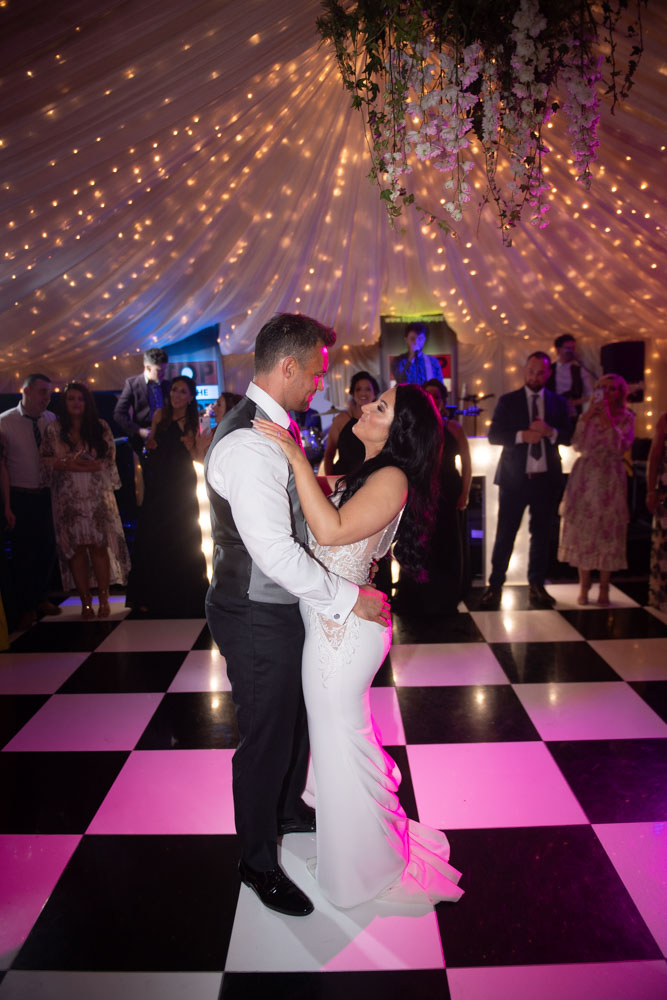 Bride and groom dancing their first dance in marquee at castle leslie