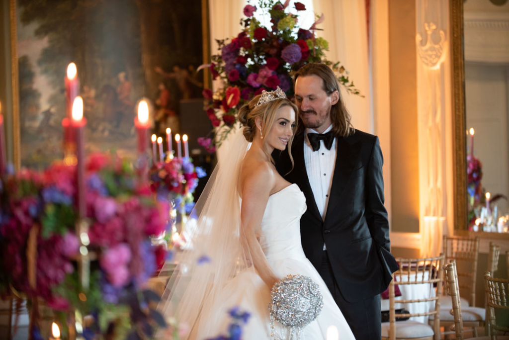 couple smiling in luttrellstown wedding reception room surrounded by candles and flowers