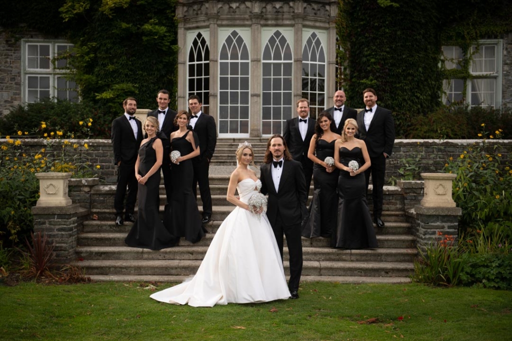 bridal party wearing black on steps at luttrellstown castle in ireland