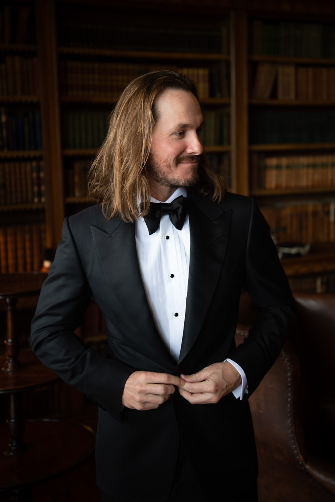 Groom closing suit jacket in Luttrellstown library