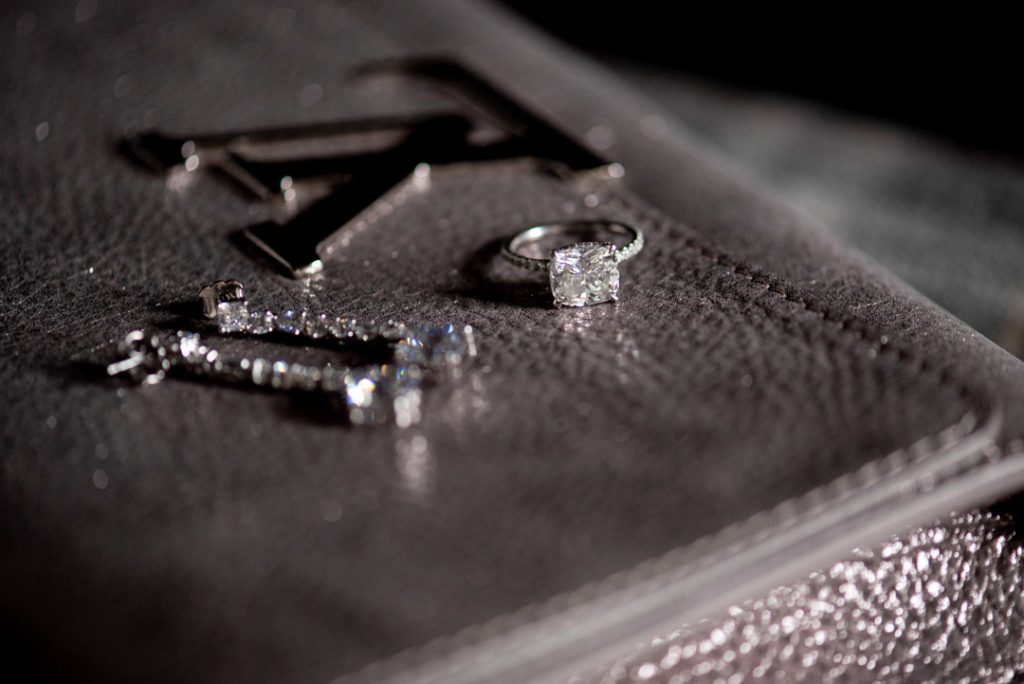 Engagement ring and Brides earrings on Louis Vuitton handbag