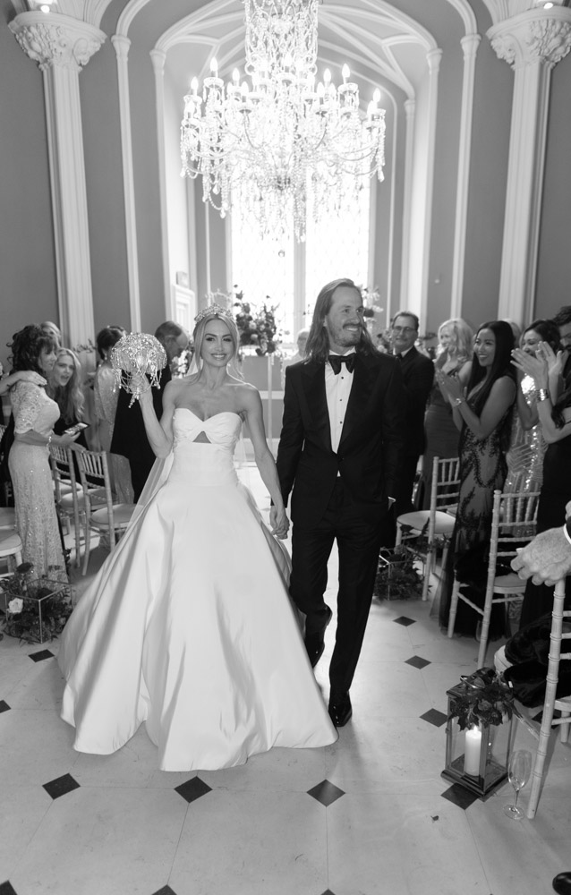 Bride and Groom smiling walking down aisle at Luttrellstown Castle ceremony room