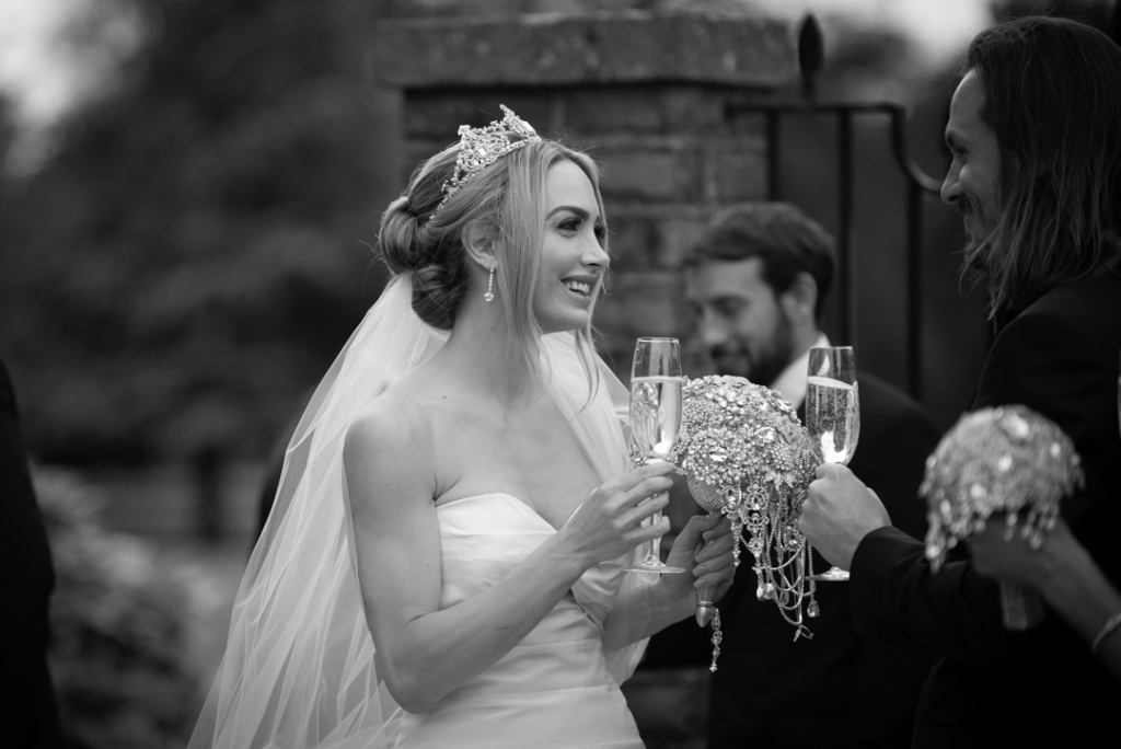 Bride and Groom clinking champagne glasses at Luttrellstown Castle