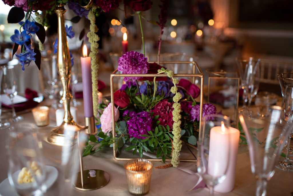 Flowers on table in a small square geometric stand